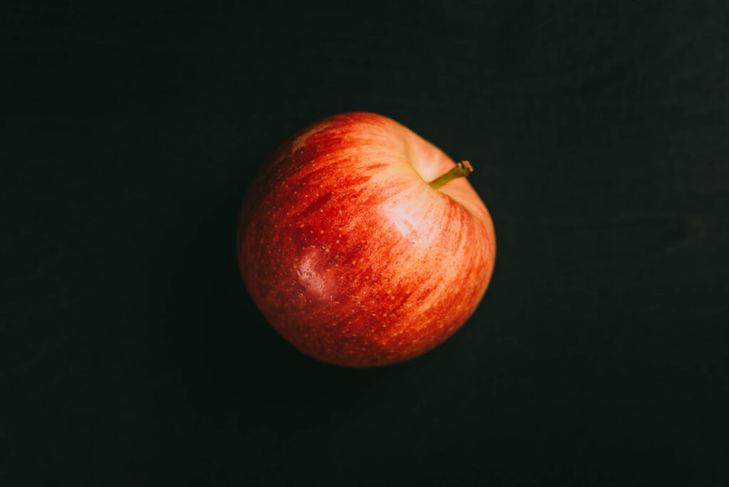 red apple on black background