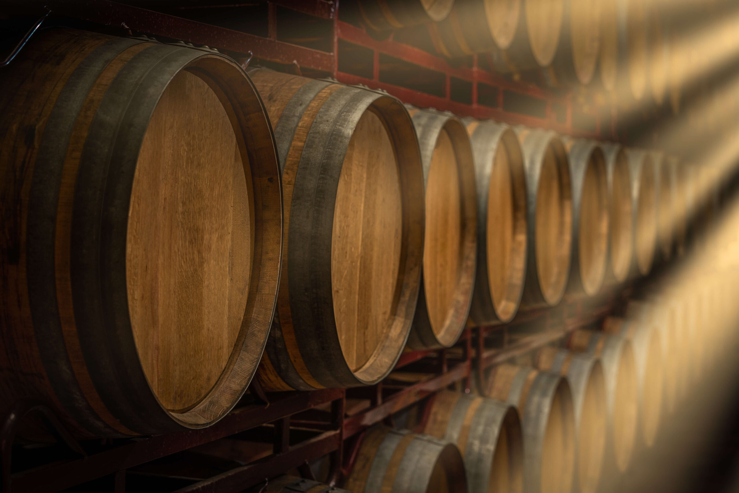 wooden barrels in line with light rays